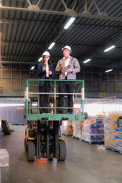 istock Distribution warehouse manager and client businesswoman using digital tablet checking inventory storage on shelf. Storehouse business worker and logistic engineer standing together at storage service 2222393635