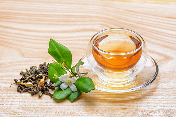 istock Jasmine green tea in clear cup on wooden table 2222395055