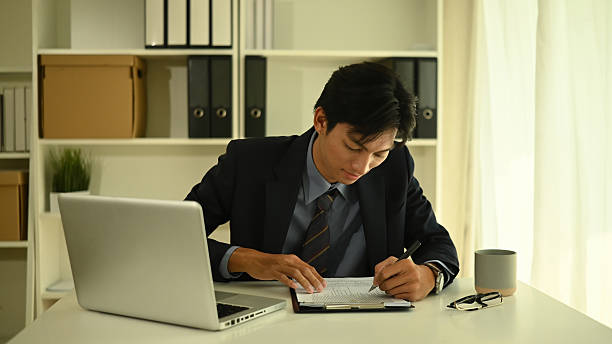 istock Focused executive signing critical business documents at office desk, Corporate planning and administrative decision making scene 2222395095
