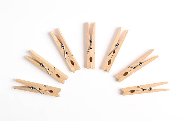 Wooden clothes pin isolated on white background. Top view, flat lay