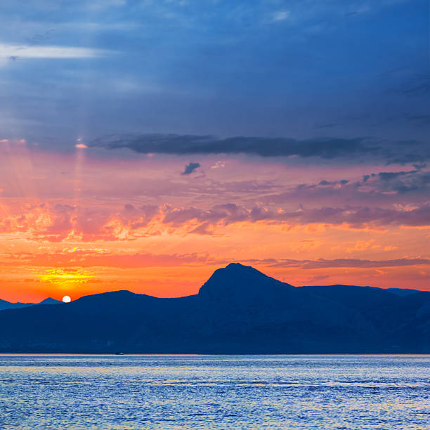 rocky sea coast silhouette at the dramatic sunset