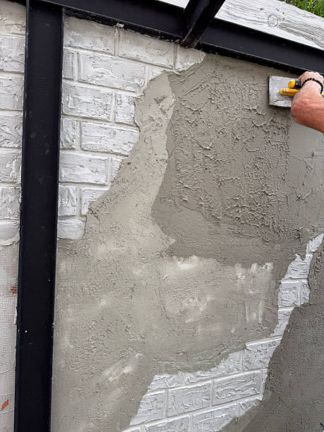 istock Male hand working with cement on brick wall, creating decorative texture. Concept of construction, renovation, plastering and manual labor in building industry 2222400094