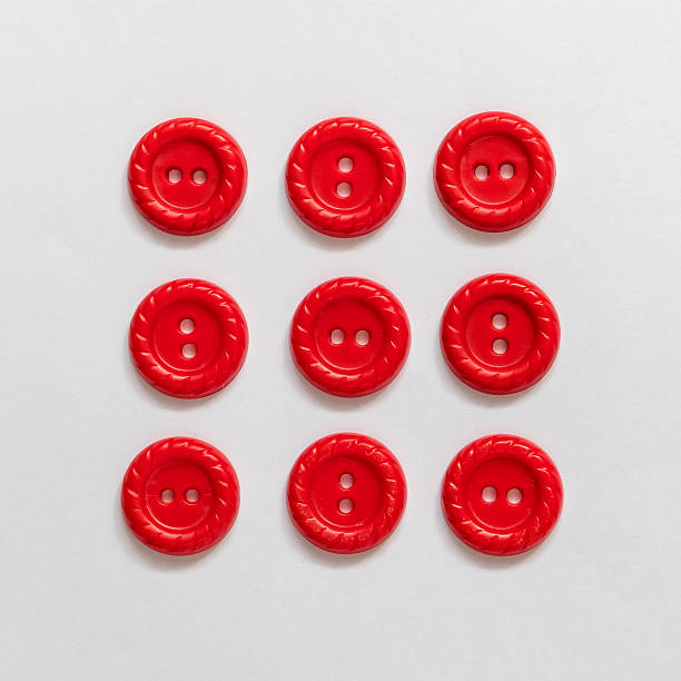 istock Set of red plastic buttons on a white background. Sewing tools. Top view. 2222403145