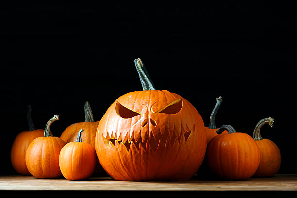 istock Halloween composition with carved jack-o-lantern pumpkin in center 2222403751