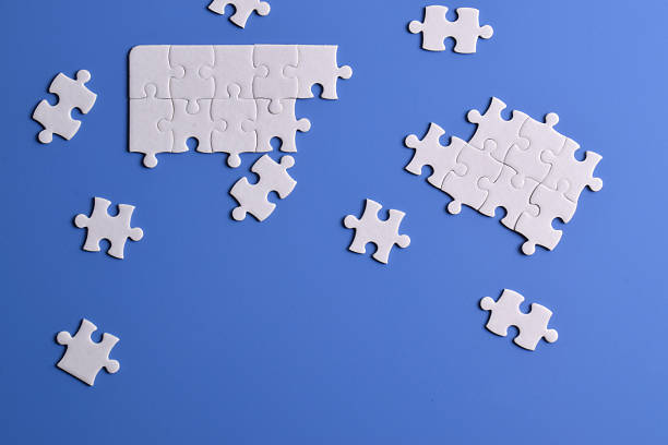 istock White puzzle pieces on blue background 2222403762