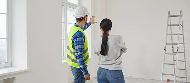 istock Professional repairman explaining future home design plan to young woman 2222403814