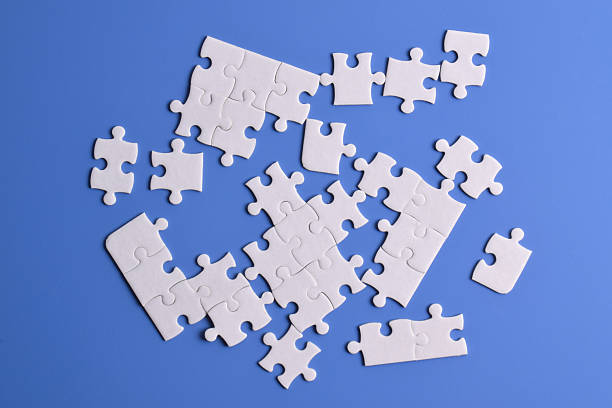 istock White puzzle pieces on blue background 2222403919