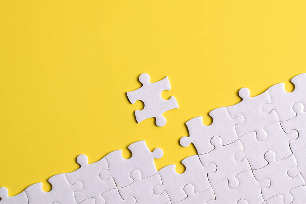 istock White puzzle pieces on yellow background 2222405214