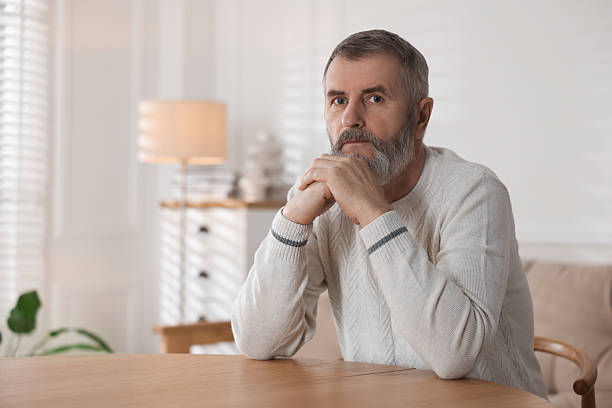 istock Senior man at table indoors, space for text 2222405255