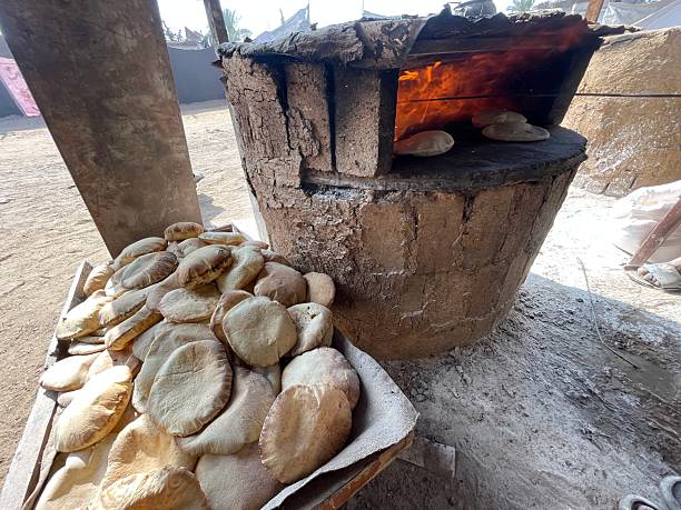istock Clay oven operated by firewood, traditional countryside baking method. 2222405349