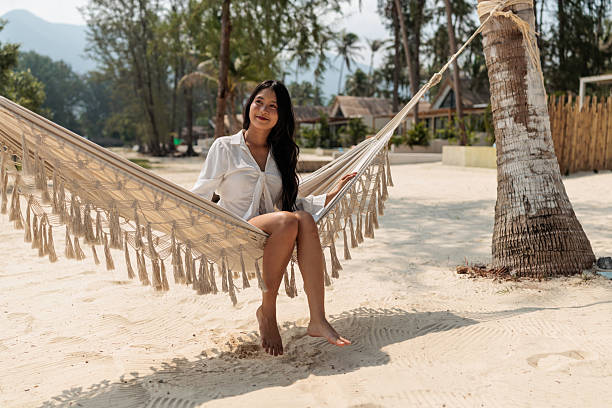 istock Young girl relaxing on a hammock on the beach 2222406167