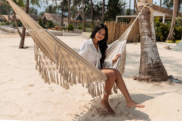 istock Young girl relaxing on a hammock on the beach 2222406218