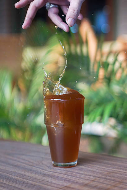 istock Hand put ice on a glass of drink 2222406291