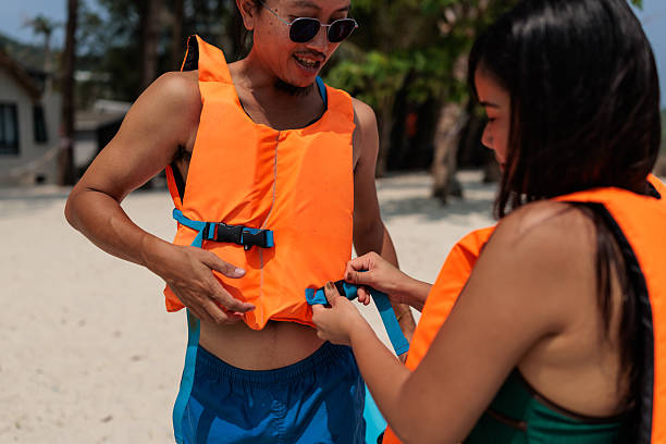 Women tourist are wearing life jackets bfore going activity on ocean.watersport fun on summer beach vacation.