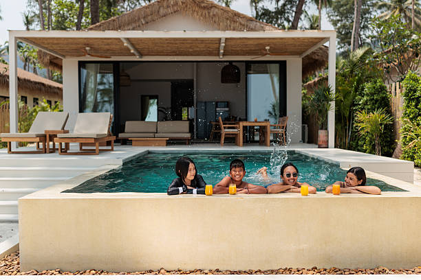 istock Family Relaxing by the Pool with Refreshing Summer Drinks 2222408802