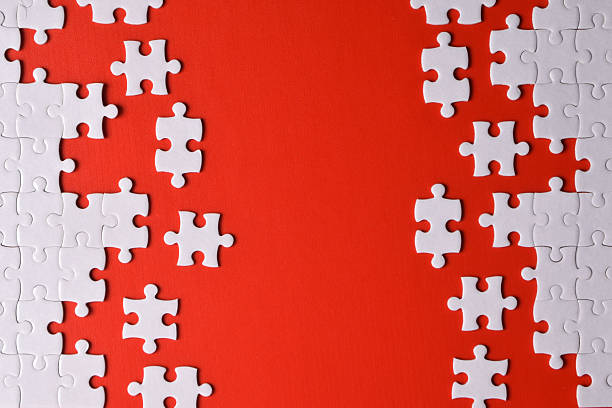 White puzzle pieces isolated on red background, top view. Space for text