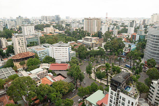 Ho Chi Minh City, Vietnam - May 09, 2025: an elevated view of the Ho Chi Minh City urban landscape with buildings and green areas during the day in Vietnam.