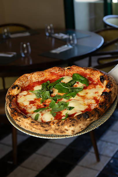 istock Margherita pizza in the waiter's hand 2222411610