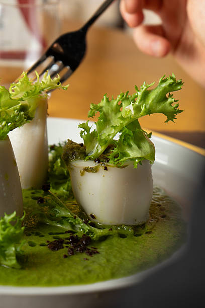 Squid with peas and salad on the fork