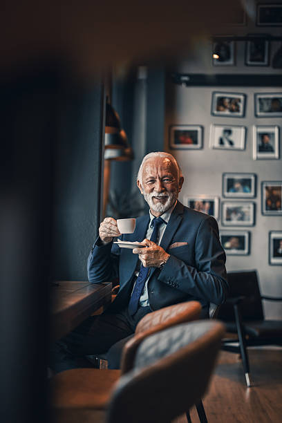 istock Senior Man Enjoying Coffee in a Cozy Urban Setting 2222414595