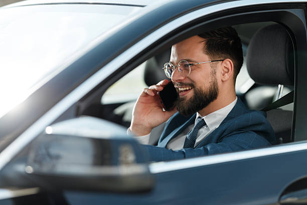 istock Businessman Talking on Phone by Car 2222418665