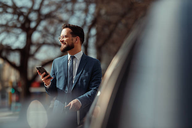 istock Businessman With Suitcase Checking Phone 2222418678