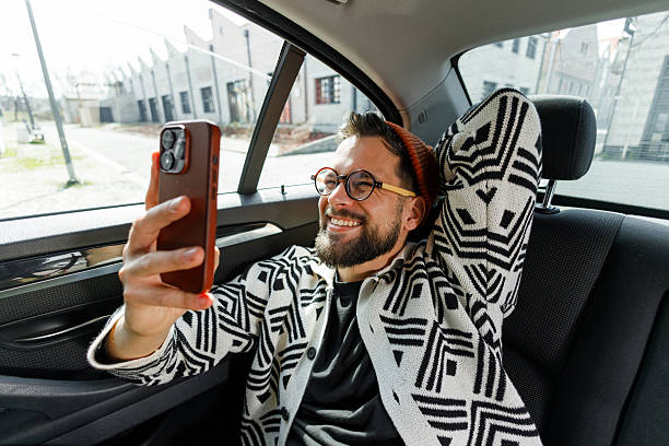 istock Man Having Video Call in Car Backseat 2222418694