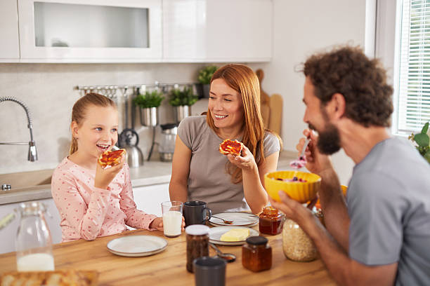 istock Happy family having breakfast together in the kitchen 2222421466