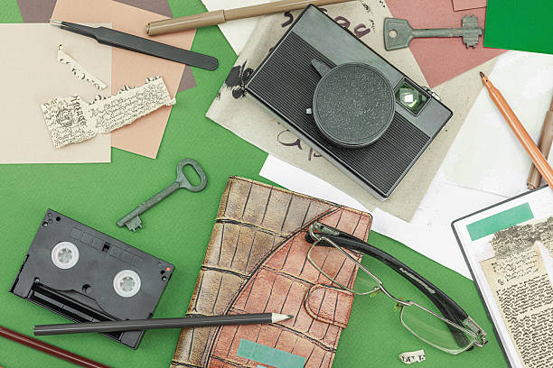 Flat lay with vintage camera, cassette, notebook, key and research tools on green background, symbolizing journalism, OSINT, and the pursuit of truth, top view