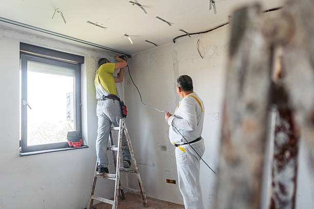 istock Two Mature Workers Installing Gypsum Board Profiles With A Drill On The Ceiling In An Empty Apartment Under Renovation 2222422461