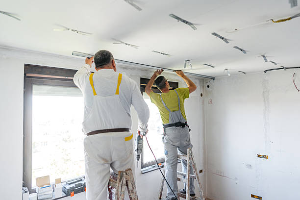 istock Two Mature Workers Installing Gypsum Board Profiles On The Ceiling In An Empty Apartment Under Renovation 2222422499