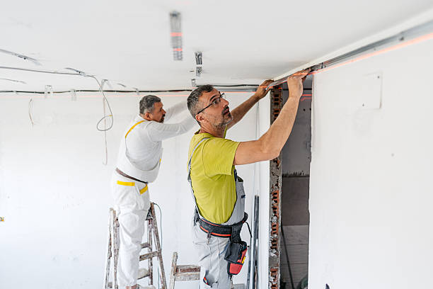 istock Two Mature Workers Installing Gypsum Board Profiles On The Ceiling In An Empty Apartment Under Renovation 2222422742