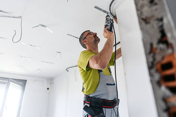 istock Mature Worker Installing Drywall Spacers With A Drill On The Ceiling In An Empty Apartment Under Renovation 2222422952