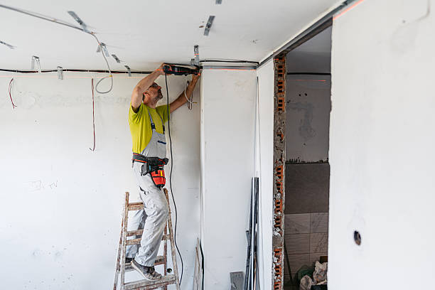 istock Mature Worker Installing Gypsum Board Profiles With A Drill On The Ceiling In An Empty Apartment Under Renovation 2222423163