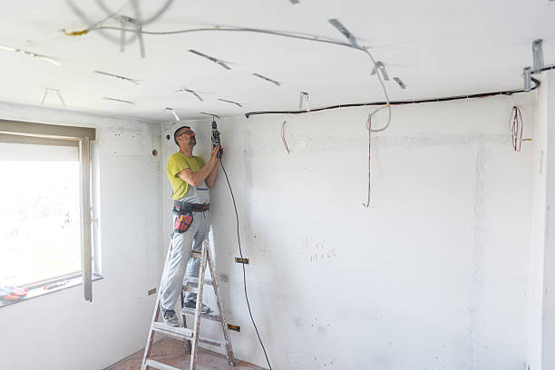 istock Mature Worker Installing Drywall Spacers With A Drill On The Ceiling In An Empty Apartment Under Renovation 2222423183