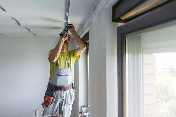 istock Mature Worker Installing Gypsum Board Profiles With A Drill On The Ceiling In An Empty Apartment Under Renovation 2222423344