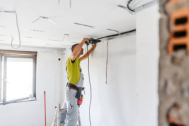 istock Mature Worker Installing Gypsum Board Profiles With A Drill On The Ceiling In An Empty Apartment Under Renovation 2222423448