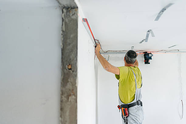 istock Mature Worker Installing Gypsum Board Profiles On The Ceiling In An Empty Apartment Under Renovation 2222423614