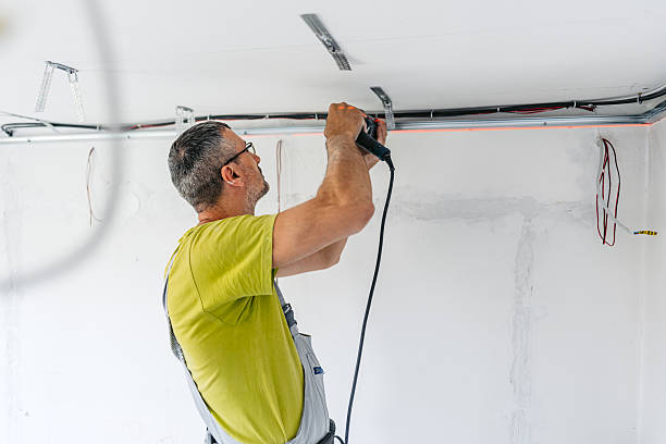 istock Mature Worker Installing Gypsum Board Profiles With A Drill On The Ceiling In An Empty Apartment Under Renovation 2222423631