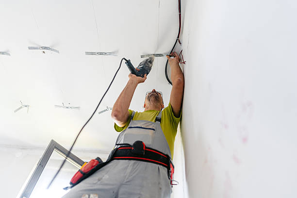 istock Mature Worker Installing Drywall Spacers With A Drill On The Ceiling In An Empty Apartment Under Renovation 2222423680