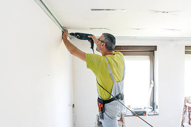 istock Mature Worker Installing Gypsum Board Profiles With A Drill On The Ceiling In An Empty Apartment Under Renovation 2222423805