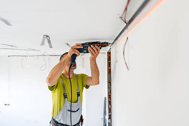 istock Mature Worker Installing Gypsum Board Profiles With A Drill On The Ceiling In An Empty Apartment Under Renovation 2222423824