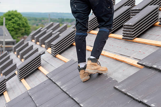istock Roofer carefully places slate roofing tiles on a structure's roof ensuring proper alignment and stability 2222426572
