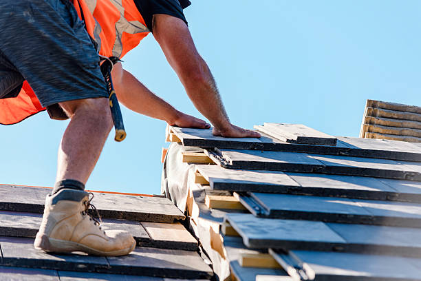 istock Roofer installing roof tiles using nails and hammer 2222427922