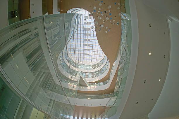 Modern building interior with curved floors, skylights and glass walls (Takasaki city central library)