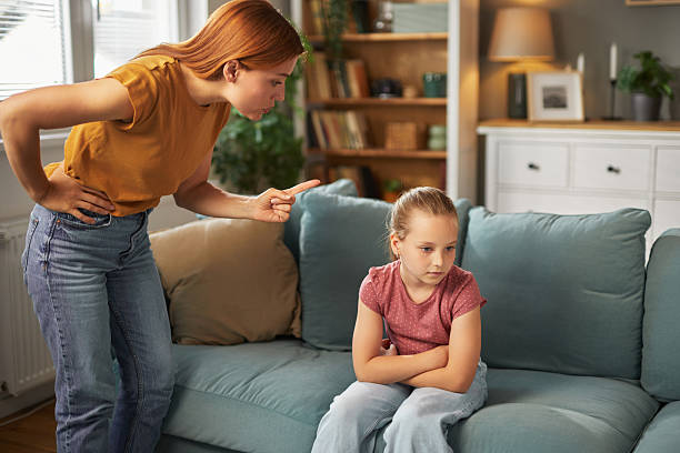 istock Mother scolding daughter at home after misbehavior 2222428671