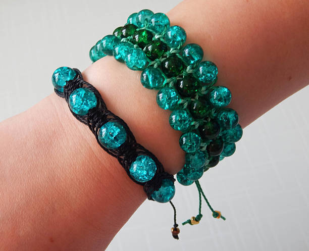 istock Female hand with green bracelet 2222428819