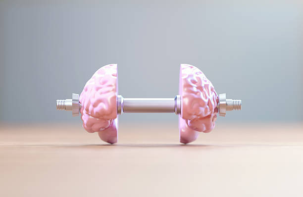 istock Brain Shaped Pink Dumbbell In Front Of Gray Background 2222429592