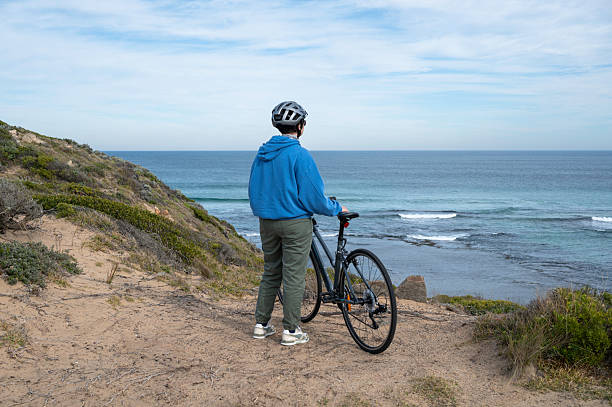 istock Female Cyclist Gazing at Ocean Horizon 2222430484