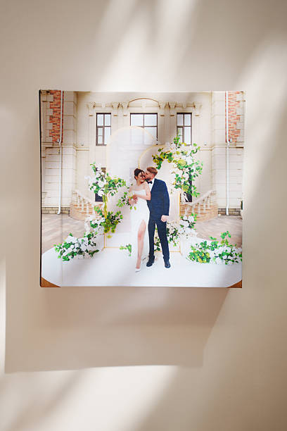 a closed photo book with wedding photos on a white table